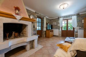 a large living room with a stone fireplace at Activity and familiy Villa Milena with heated pool in Kršan