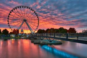 a ferris wheel on a bridge over a river at Plateau Escape & Nightlife Adventures! Downtown Super Value! Full 1BR Apartments in Montréal