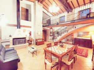 a living room with a wooden table and a fireplace at Le Stanze del Casale Morolo in Morolo