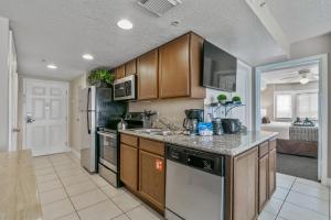 a kitchen with wooden cabinets and a counter top at Silver Lake Resort in Orlando