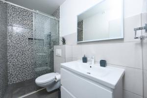 a white bathroom with a toilet and a sink at MY DALMATIA - Sea view villa Possedaria with amazing roof terrace in Posedarje +36 photos