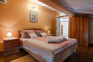 a bedroom with a large bed with orange walls at Activity and familiy Villa Milena with heated pool in Kršan +72 photos
