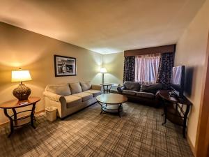 a living room with a couch and a table at Heritage Inn in Great Falls