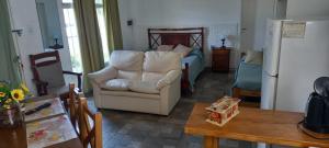 Una sala de estar con un sofá blanco y un dormitorio. en Departamento Familiar con estacionamiento incluido, en Bahía Blanca