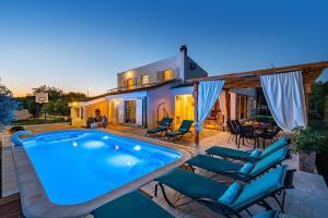 a swimming pool in front of a house at MY DALMATIA - Villa Elia with private pool and panoramic sea view in Zadar