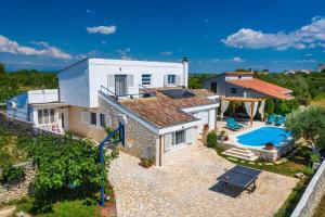 an aerial view of a house with a swimming pool at MY DALMATIA - Villa Elia with private pool and panoramic sea view in Zadar