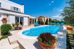 a swimming pool in the backyard of a house at MY DALMATIA - Villa Elia with private pool and panoramic sea view in Zadar +58 photos