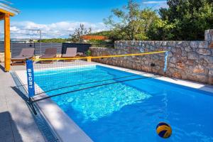 a swimming pool with a volley ball in it at MY DALMATIA - Sea view villa Nana with private swimming pool in Lukoran