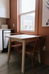 a table and chairs in a kitchen with a window at Beecomb House Modern Water View House in Charlottetown +19 photos