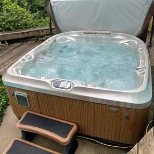 a jacuzzi tub sitting on top of a deck at Riverside Retreat with Sauna & Hot Tub in Elora in Elora