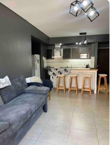 a living room with a couch and a kitchen at Ballester city in Villa Ballester +13 photos