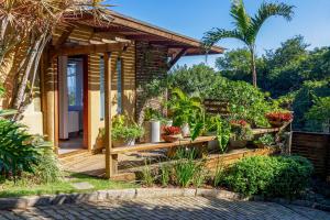 a house with a garden with potted plants at Gringos Boutique Hotel in Búzios +40 photos