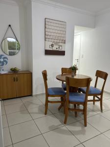 a dining room with a table and chairs at Apartamento Poleto's in Bertioga