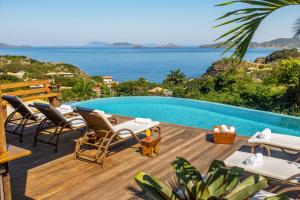 a villa with a pool and a view of the ocean at Gringos Boutique Hotel in Búzios