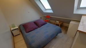 a small bedroom with a bed and a window at Maison avec Parking, proche Tours in Vouvray