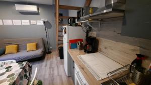 a small room with a refrigerator and a bed at Maison avec Parking, proche Tours in Vouvray +18 photos