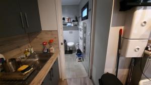 a kitchen with a sink and a refrigerator at Maison avec Parking, proche Tours in Vouvray