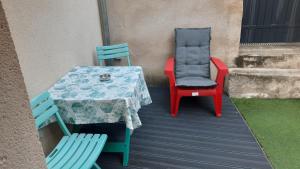 a table and two chairs sitting on a deck at Maison avec Parking, proche Tours in Vouvray
