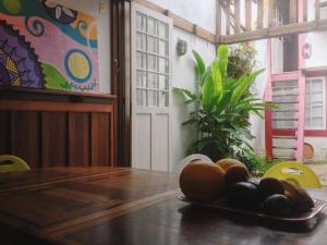 a table with a plate of fruit on top of it at Casa de Hospedagem Paraty in Paraty