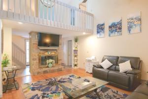 a living room with a couch and a fireplace at Charming Home near I-87 JCT in Queensbury