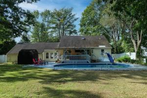 a house with a swimming pool in the yard at Charming Home near I-87 JCT in Queensbury