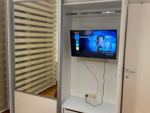 a flat screen tv on a wall in a room at Apartman M&M in Doboj
