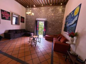 a living room with a couch and a table at Casa monarca in Morelia