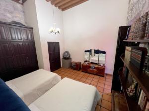 a bedroom with two beds and a mirror at Casa monarca in Morelia