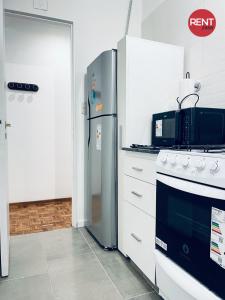a kitchen with a refrigerator and a stove at Rent Aguero in Buenos Aires +20 photos