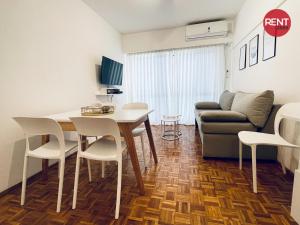 a living room with a table and chairs and a couch at Rent Aguero in Buenos Aires