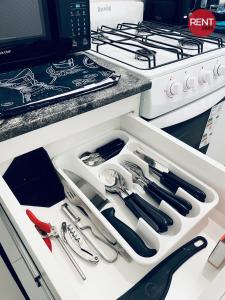 a drawer with utensils in a kitchen next to a stove at Rent Aguero in Buenos Aires