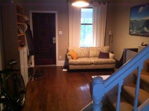 a living room with a couch and a window at Lovely home in Leslieville in Toronto