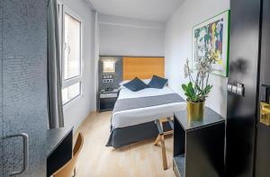 Ένα ή περισσότερα κρεβάτια σε δωμάτιο στο Hotel Faranda Pathos Gijón, Ascend Hotel Collection