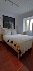a bedroom with a bed with a stuffed animal on it at Casa Augusta - The Natural Lodgings And Retreats in Águas de Verão