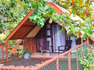 a small house with two chairs and a porch at Villa Campo's in Venecia +7 photos