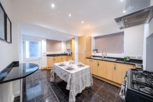 a kitchen with a table in the middle of it at Over Lane in Almondsbury