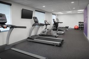 a gym with cardio machines and a flat screen tv at Holiday Inn Express Spokane Airport by IHG in Spokane