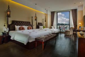 a bedroom with a large bed and a large window at Hanoi Marvellous Hotel & Spa in Hanoi