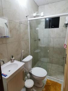 a bathroom with a shower and a toilet and a sink at Rancho do Poeta - Chalé Cajueiro in Lagoa Nova +9 photos