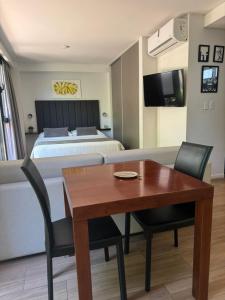 a bedroom with a bed and a dining table and a bed at Departamento a estrenar, Palermo Hollywood VII in Buenos Aires