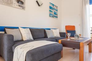 a living room with a couch and a table at Molí del Mar in L'Escala