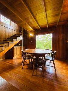 a dining room with a table and chairs and a staircase at Private House Next to the Cloud Forest Reserve in Monteverde Costa Rica