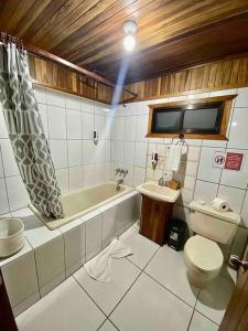 a bathroom with a tub and a toilet and a sink at Private House Next to the Cloud Forest Reserve in Monteverde Costa Rica