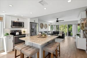 a kitchen and living room with a large island at Beautiful Kawama Townhouse-P6 in Key Largo