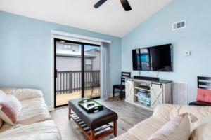 a living room with two couches and a tv at Dog Friendly 2 Bed Condo! Walk To Beach or Lagoon! in Gulf Shores