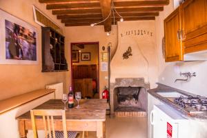 a kitchen with a table with wine glasses on it at Casa Del Sole in Camaiore