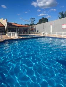 a swimming pool at a hotel with blue water at Casa de temporada imperatriz Ma in Imperatriz