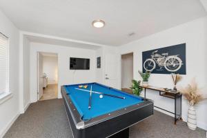 a living room with a pool table in it at Relaxing 3-Bedroom With 150 Inch Projector & Pool Table in Jacksonville