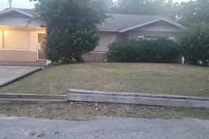 a house with a wooden fence in front of a yard at Relaxing 3-Bedroom With 150 Inch Projector & Pool Table in Jacksonville