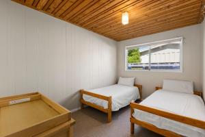 a room with two beds and a window at Pelican Point in Saint Leonards